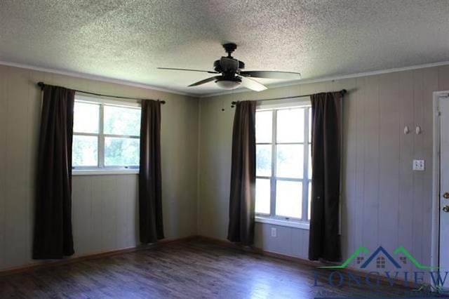 spare room featuring hardwood / wood-style floors and a healthy amount of sunlight