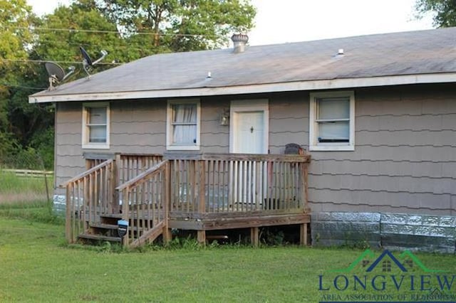 back of property with a lawn and a wooden deck