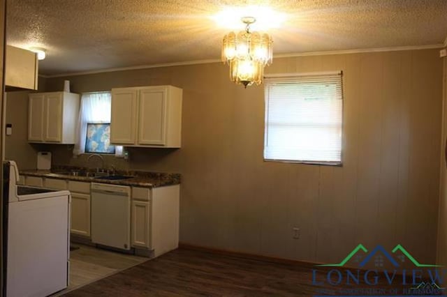 kitchen with dishwasher, range, an inviting chandelier, ornamental molding, and white cabinetry