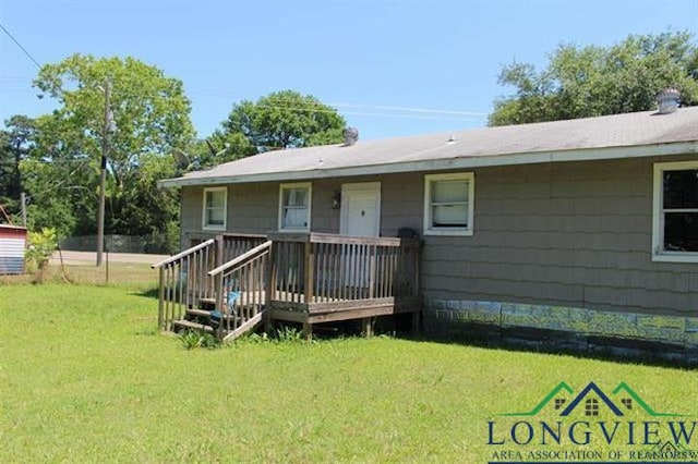 back of house with a lawn and a wooden deck