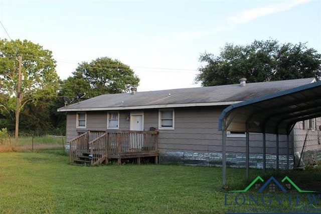 rear view of house with a carport and a lawn