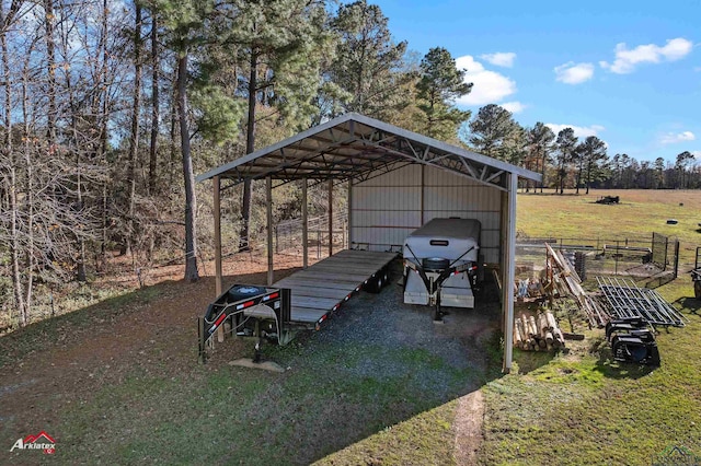 view of yard featuring a rural view and a carport