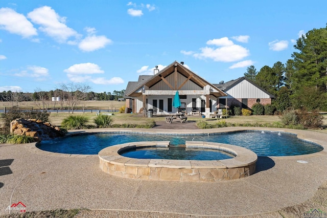 view of pool with an in ground hot tub and a patio area