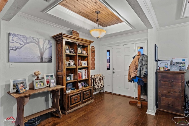 foyer entrance featuring dark wood-type flooring and crown molding