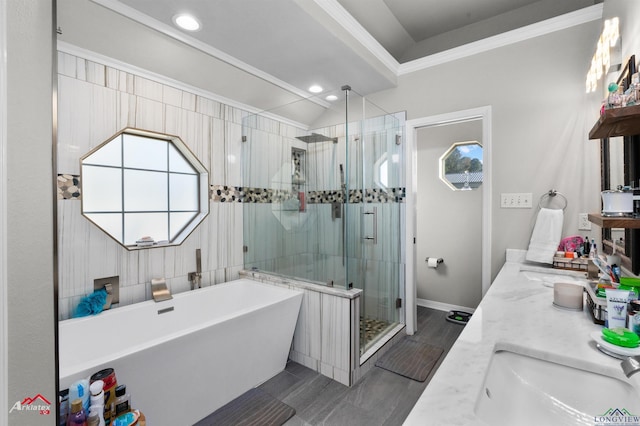 bathroom featuring crown molding, vanity, and shower with separate bathtub