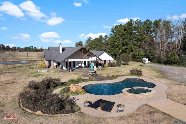 view of swimming pool with a patio area and an in ground hot tub