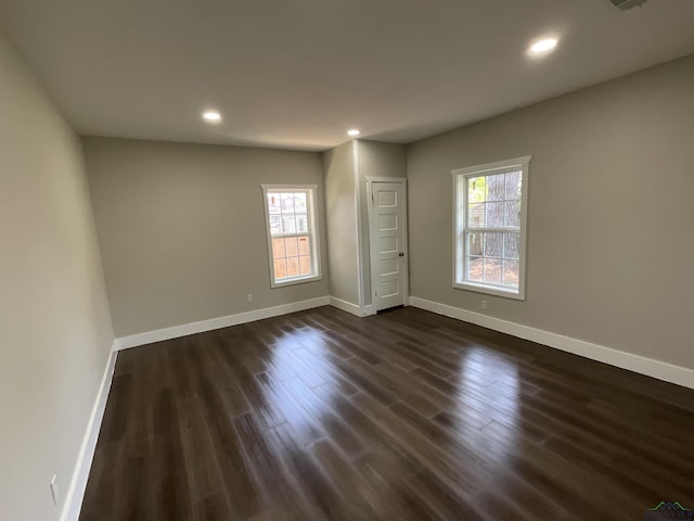 unfurnished bedroom featuring recessed lighting, dark wood-style floors, and baseboards