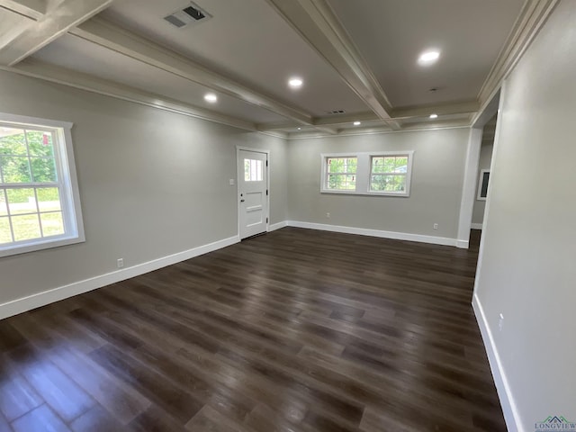 unfurnished room featuring beamed ceiling, ornamental molding, dark wood-style flooring, baseboards, and visible vents