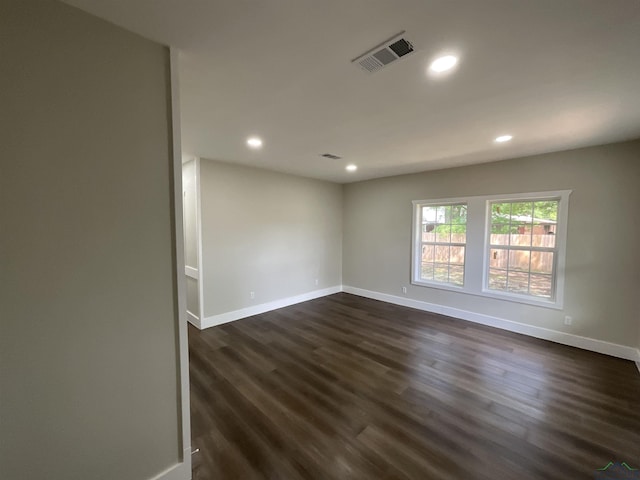 unfurnished room featuring visible vents, recessed lighting, dark wood finished floors, and baseboards