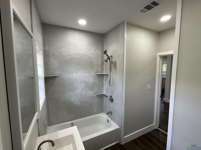 bathroom with recessed lighting, visible vents, bathtub / shower combination, and wood finished floors