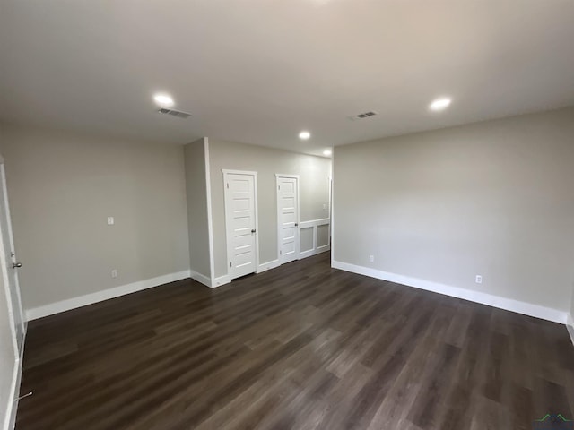 interior space with dark wood-type flooring, visible vents, recessed lighting, and baseboards