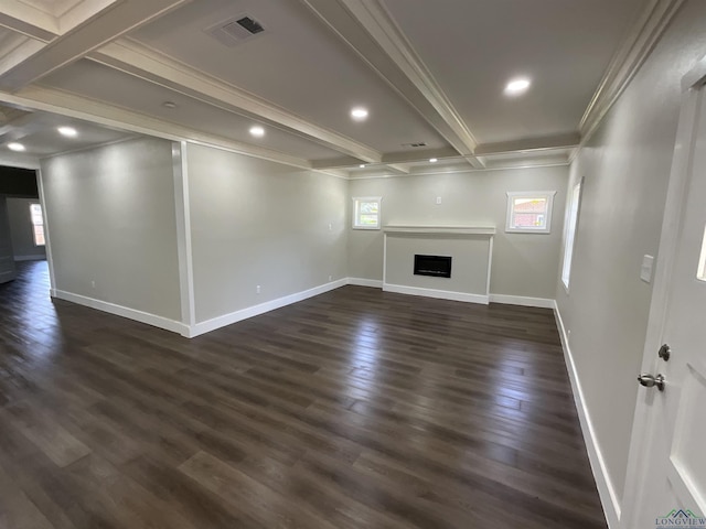 unfurnished living room with beam ceiling, dark wood-type flooring, visible vents, and crown molding