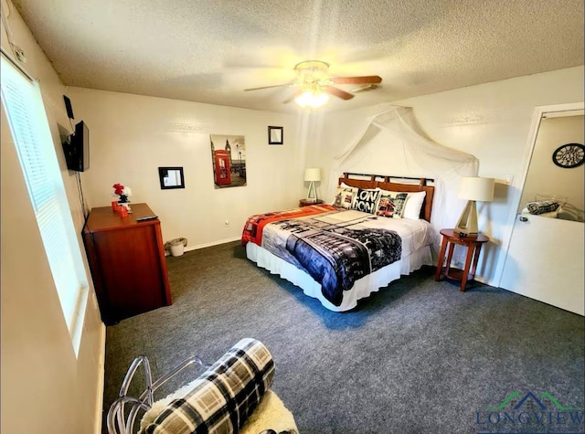 bedroom with a textured ceiling, ceiling fan, and dark carpet