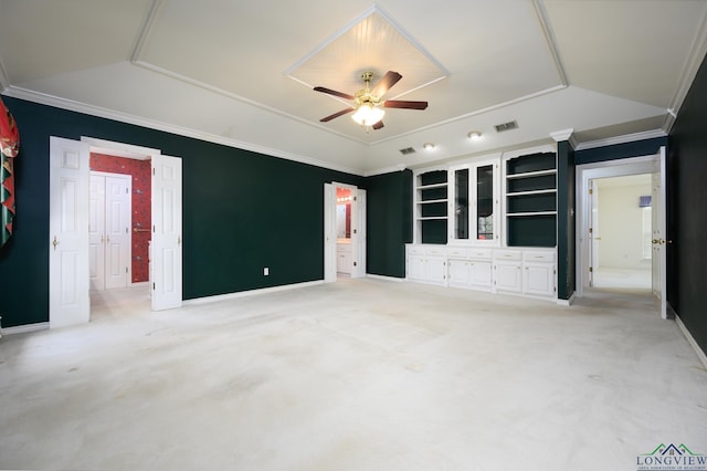 unfurnished bedroom with crown molding, light colored carpet, visible vents, a raised ceiling, and baseboards