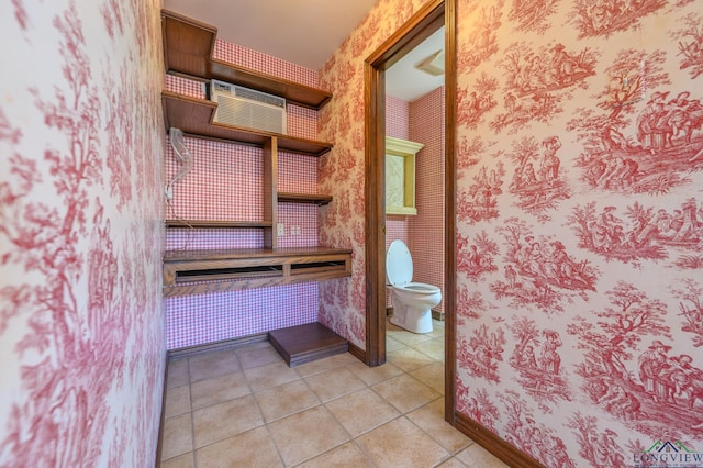 bathroom featuring toilet, wallpapered walls, and tile patterned flooring