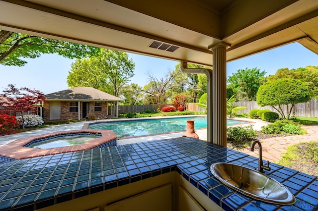 view of pool with a fenced backyard, an outbuilding, an in ground hot tub, a fenced in pool, and a storage structure