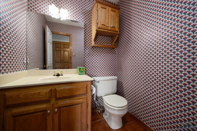bathroom featuring tile patterned floors, toilet, vanity, and wallpapered walls
