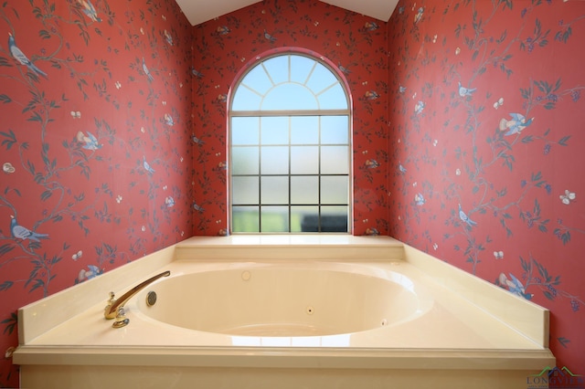 bathroom featuring wallpapered walls, a whirlpool tub, and a wealth of natural light