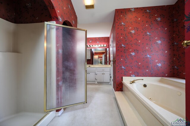 bathroom with a stall shower, wallpapered walls, vanity, and a tub with jets