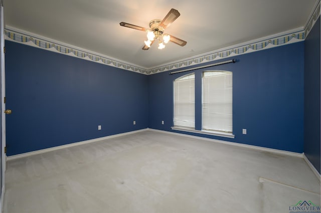 empty room with carpet flooring, ceiling fan, and baseboards