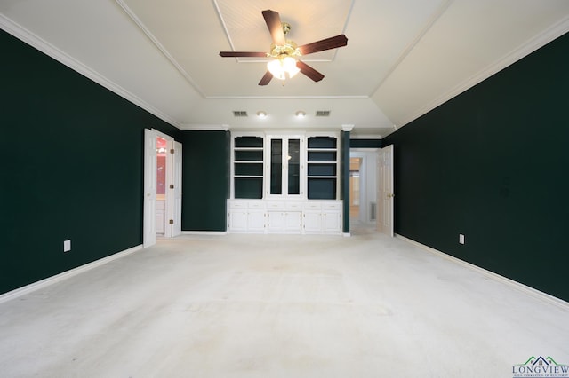 spare room featuring visible vents, ceiling fan, crown molding, light carpet, and lofted ceiling