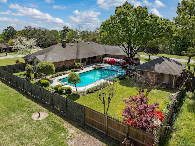 view of swimming pool featuring a yard, a fenced backyard, a pool with connected hot tub, and a patio area