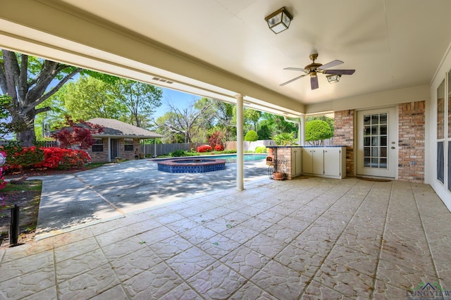 view of patio / terrace with a pool with connected hot tub, a fenced backyard, an outdoor structure, and a ceiling fan
