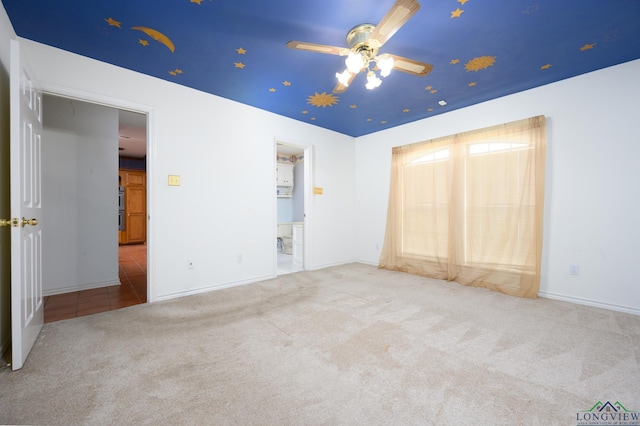 unfurnished bedroom featuring carpet and baseboards
