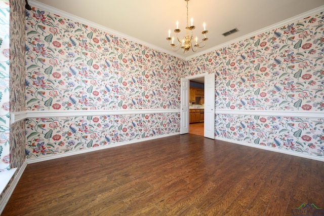 empty room featuring wallpapered walls, an inviting chandelier, baseboards, and dark wood finished floors