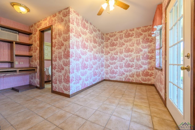 spare room featuring wallpapered walls, baseboards, and a ceiling fan