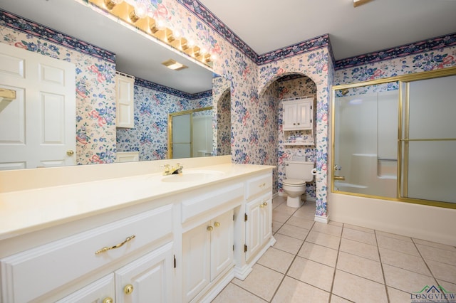 bathroom with tile patterned flooring, vanity, wallpapered walls, and toilet