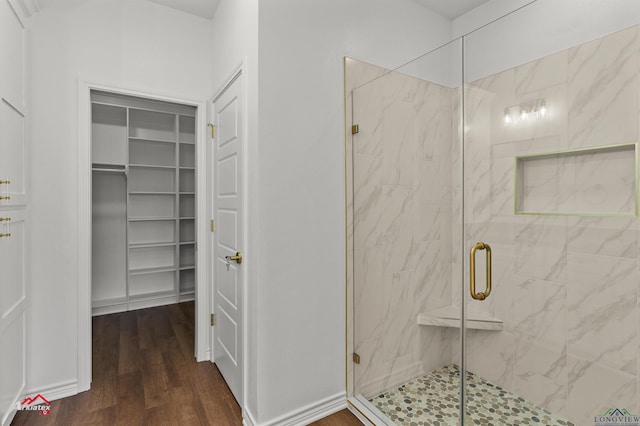 bathroom featuring hardwood / wood-style flooring and an enclosed shower