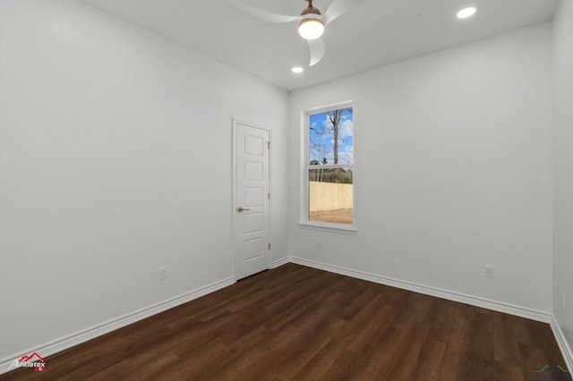 spare room with ceiling fan and dark hardwood / wood-style flooring