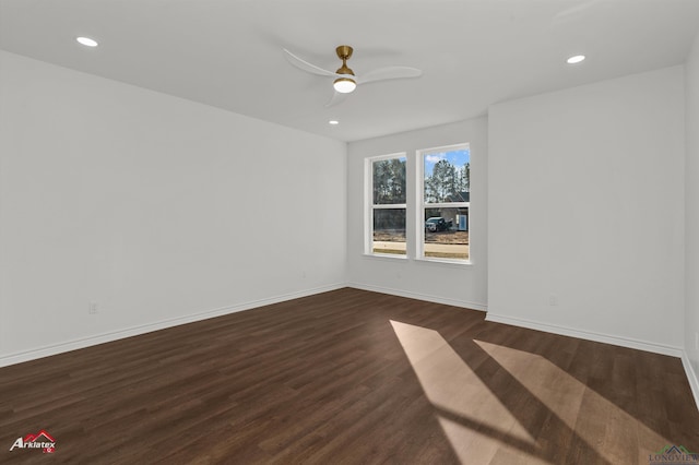 spare room featuring dark hardwood / wood-style flooring and ceiling fan