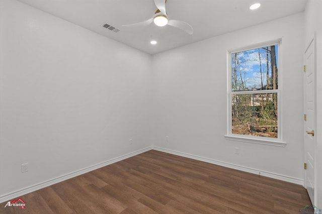 empty room featuring ceiling fan and dark wood-type flooring