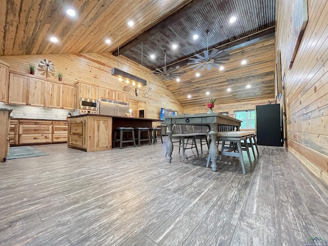 dining room with wood ceiling, ceiling fan, wooden walls, high vaulted ceiling, and dark hardwood / wood-style flooring