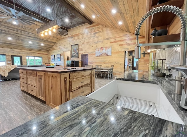 kitchen featuring wooden ceiling, ceiling fan, and wood walls