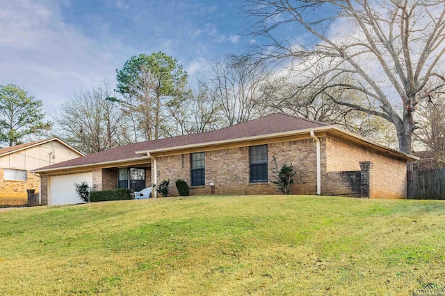 ranch-style house featuring a garage and a front yard