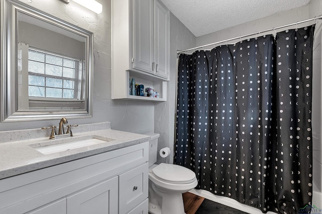 bathroom with toilet, hardwood / wood-style floors, a textured ceiling, curtained shower, and vanity