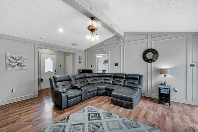 living room with hardwood / wood-style flooring and a textured ceiling