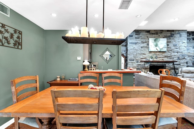 414 Harper Dr, Marshall, TX 75672 - dining space with a stone fireplace, visible vents, and recessed lighting