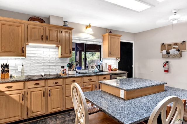 414 Harper Dr, Marshall, TX 75672 - kitchen featuring dark stone counters, decorative backsplash, a sink, and black electric cooktop