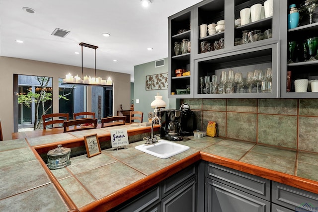 414 Harper Dr, Marshall, TX 75672 - interior space with decorative backsplash, a peninsula, a sink, and visible vents