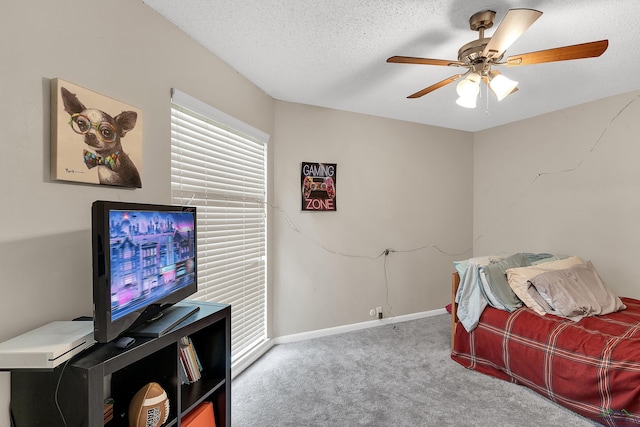 414 Harper Dr, Marshall, TX 75672 - carpeted bedroom featuring ceiling fan, a textured ceiling, baseboards, and multiple windows