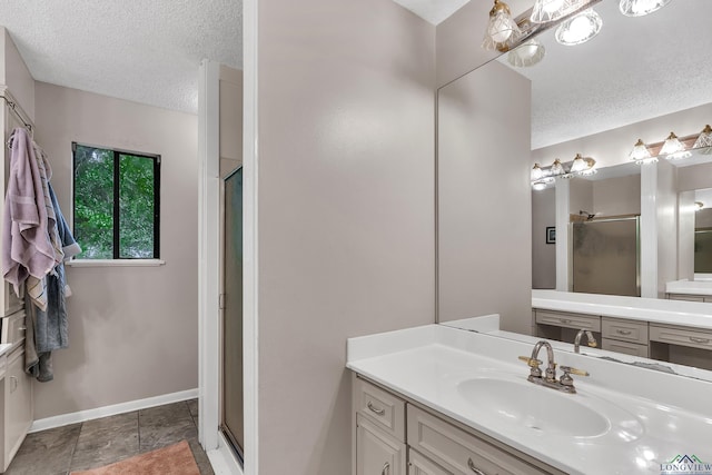 414 Harper Dr, Marshall, TX 75672 - full bathroom featuring baseboards, a shower stall, a textured ceiling, and vanity