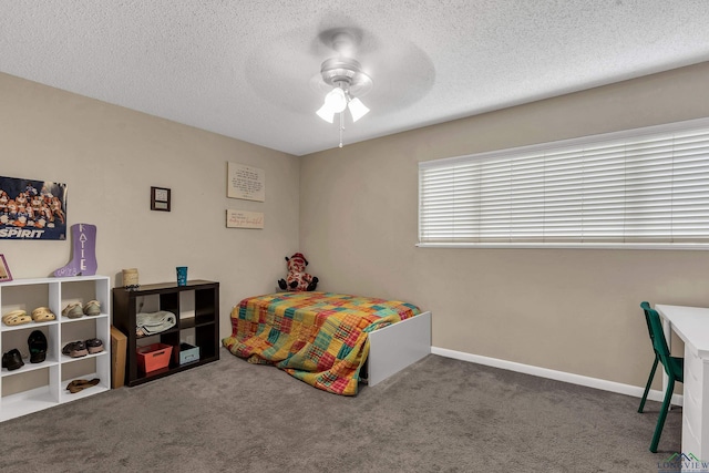 414 Harper Dr, Marshall, TX 75672 - carpeted bedroom featuring a ceiling fan, baseboards, and a textured ceiling