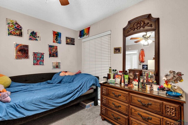 414 Harper Dr, Marshall, TX 75672 - bedroom featuring ceiling fan, light carpet, and a textured ceiling