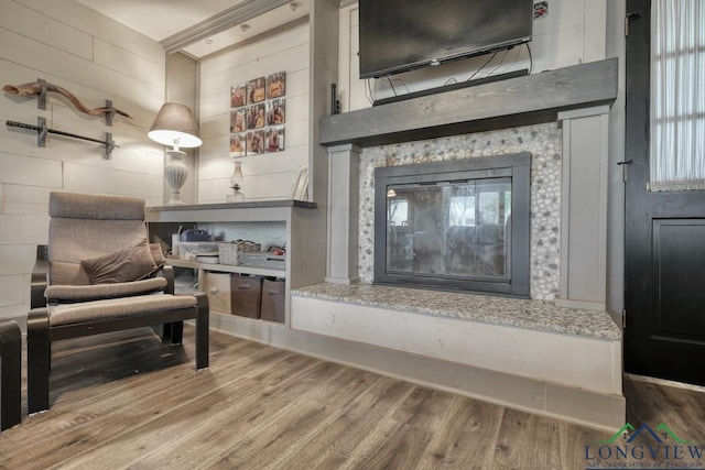 interior space featuring a glass covered fireplace and wood finished floors