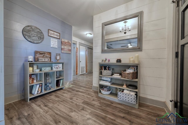 hallway with wood finished floors and baseboards