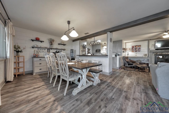 dining area featuring beamed ceiling, visible vents, ceiling fan, and dark wood-style flooring